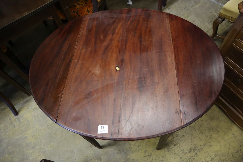 A George III mahogany Pembroke table, with oval top and moulded squared legs, width 77cm